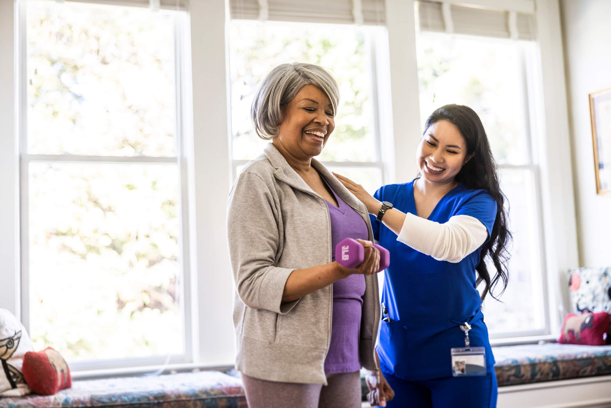 Physical therapist working with a smiling patient.